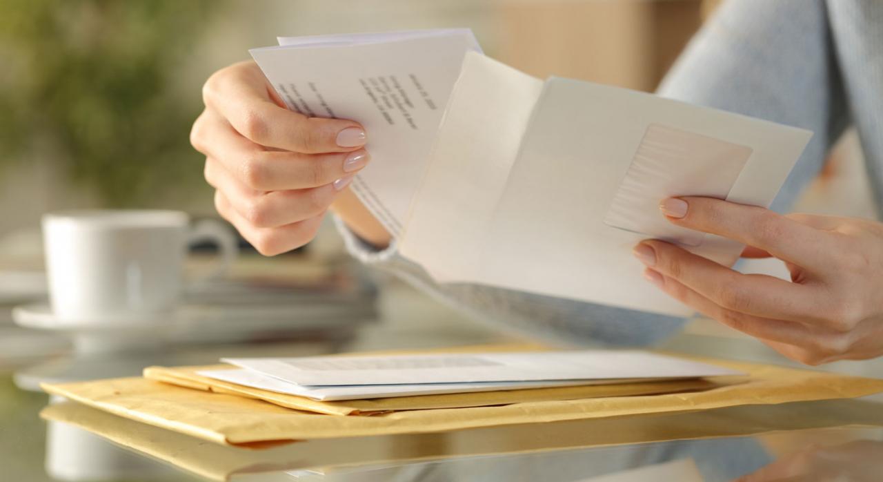 Requisitos para la inclusión de datos en un fichero de morosos Requisitos para la inclusión de datos en un fichero de morosos. Imagen de manos de chica abriendo un sobre en un escritorio en casa